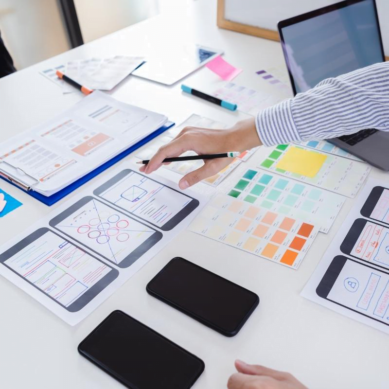 A person sketching a responsive web design for all sizes of screens