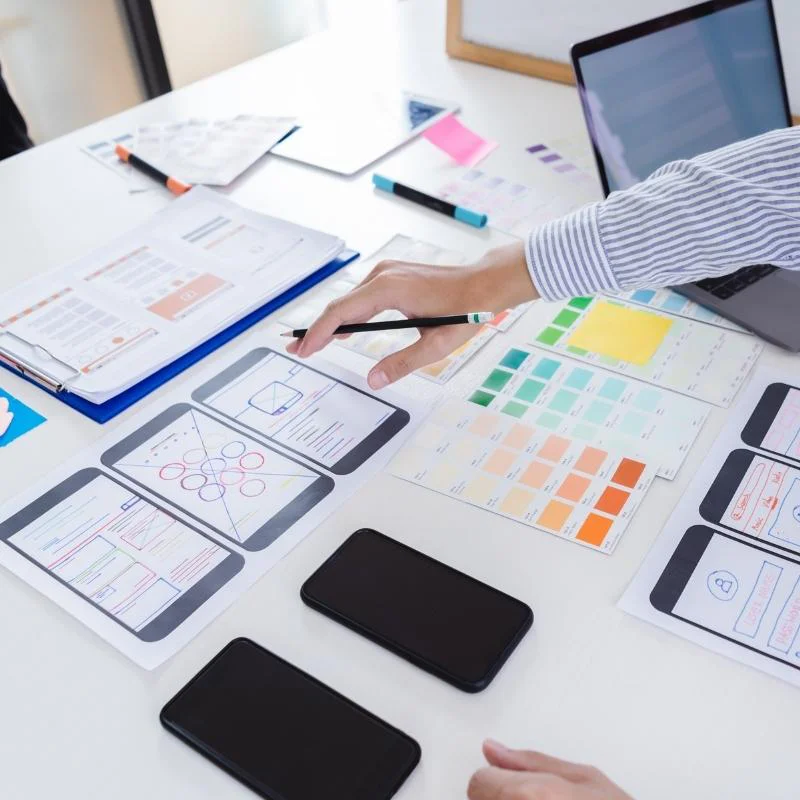 A person sketching a responsive web design for all sizes of screens