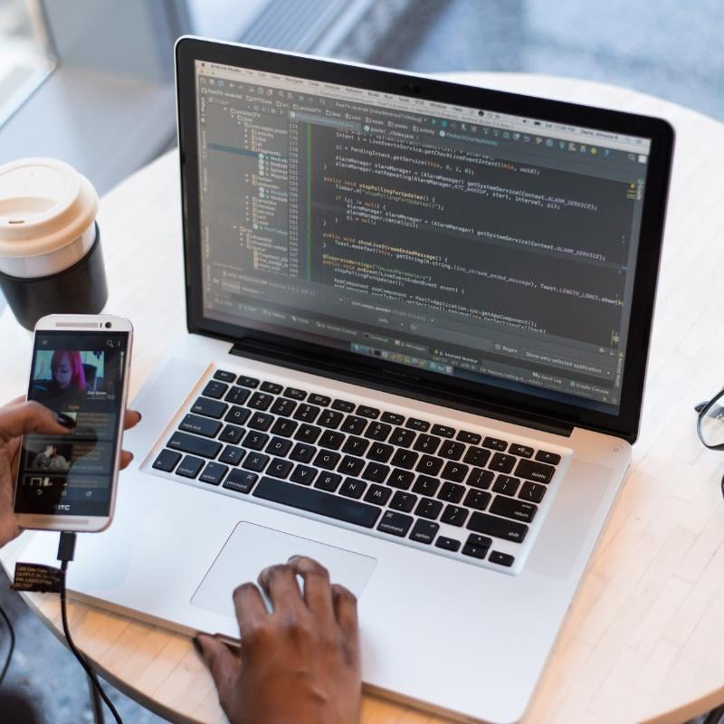 Mobile App Services 3 IOS developer coding in laptop for mobile application development